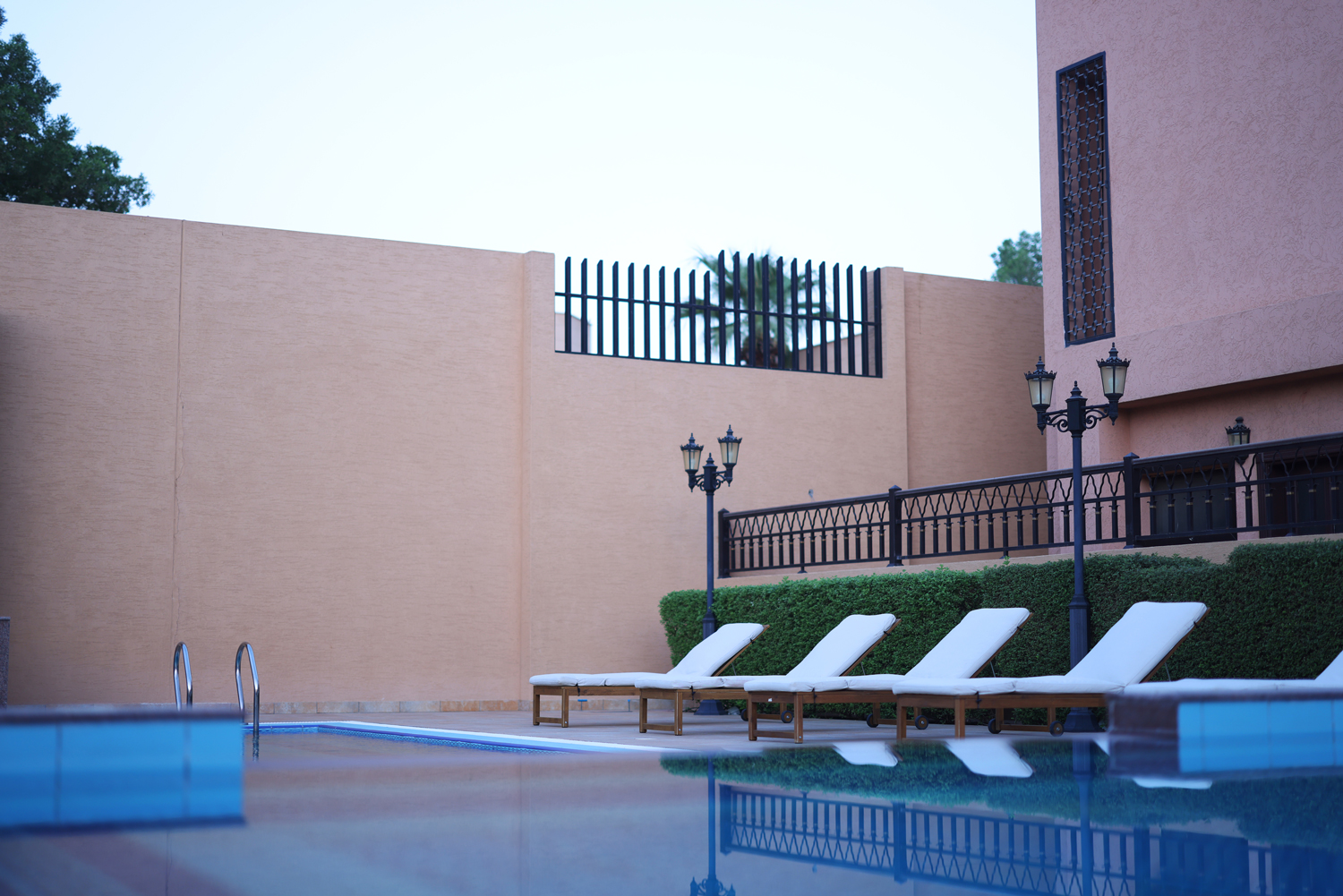 Outdoor swimming pool with lounge chairs at Creative Hospitality Compound in Saudi Arabia
